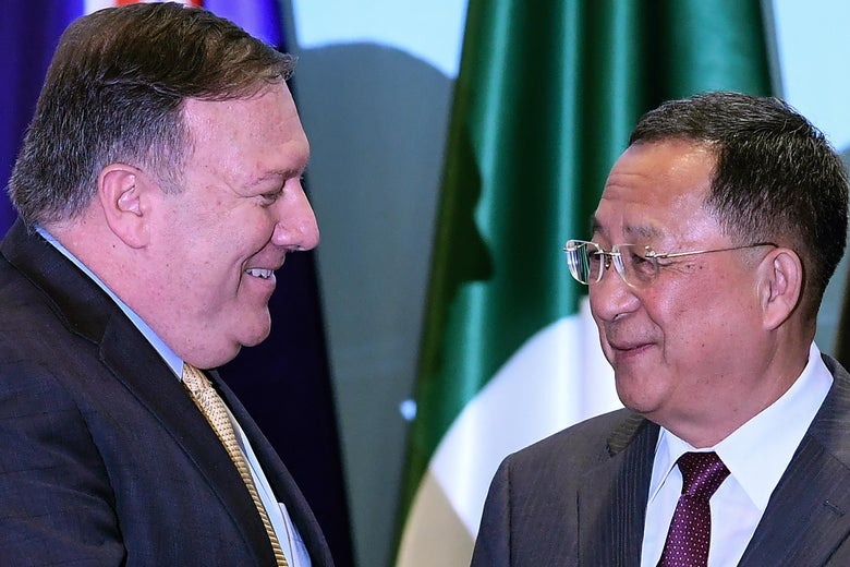 U.S. Secretary of State Mike Pompeo talks with North Korea's Foreign Minister Ri Yong Ho as they arrive for a group photo at the ASEAN Regional Forum in Singapore on August 4, 2018.